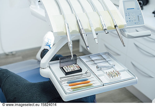Assortment of dental instruments on tray in medical practice