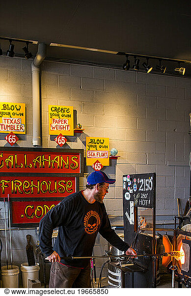 At a glass blowing studio on Whidbey Island  WA  a man makes a glass sculpture.