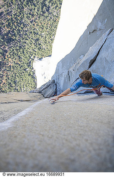 Athlete clipping climbing rope while lead climbing Changing Corners