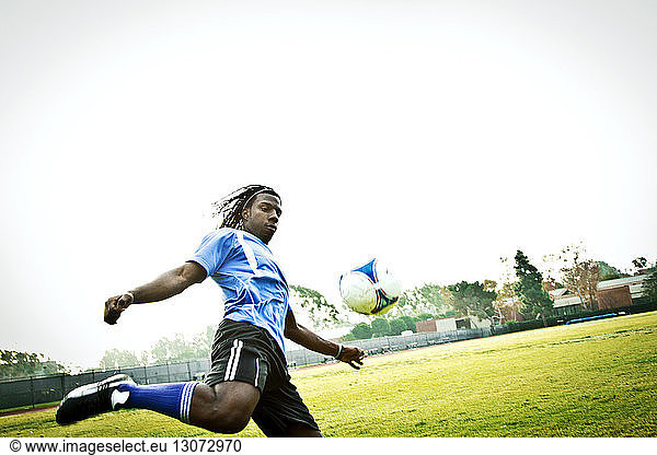 Athlete practicing soccer in field
