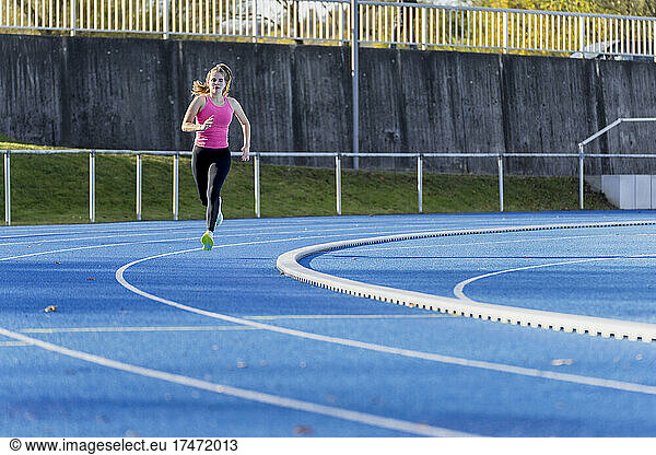 Athlete running on sports track