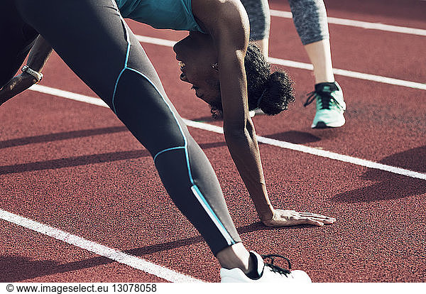 Athletes exercising on track