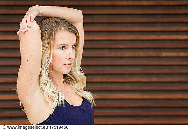 attractive blonde woman stretching arms