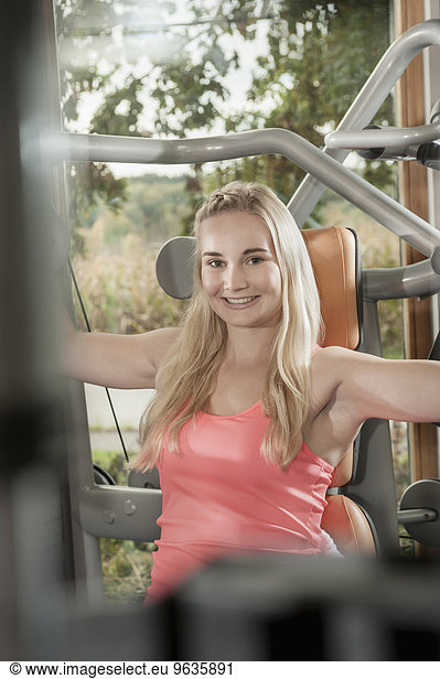Attractive smiling blond woman fitness studio