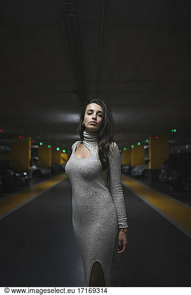 Attractive woman standing in parking garage