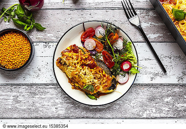 Aubergine lasagne on a plate with mixed salad