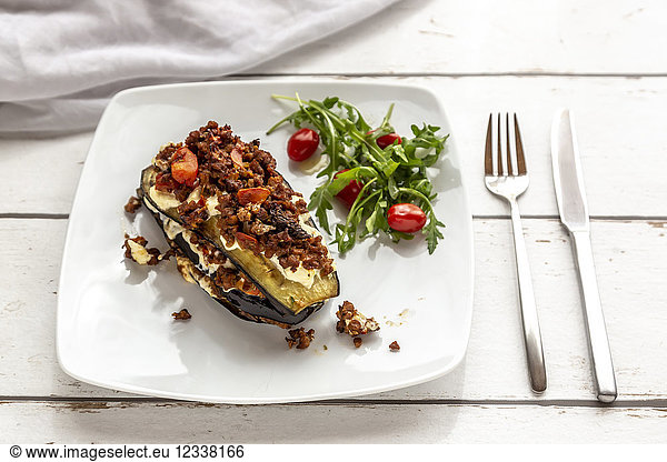 Aubergine lasagne on plate  rucola and tomato  vegetarian