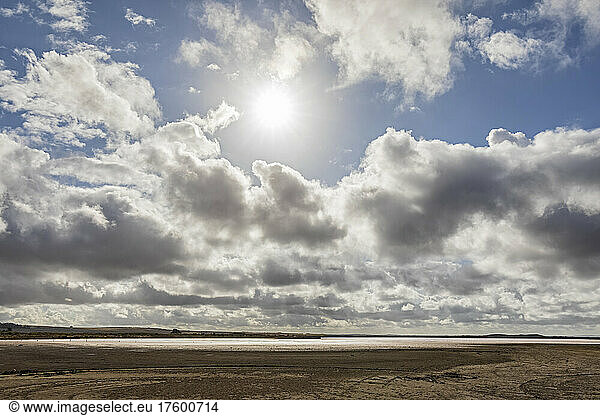 Australia  South Australia  Meningie  Sun shining through clouds over shore of Pink Lake