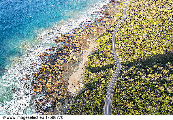 Australia  Victoria  Aerial view of rocky coastline and stretch of Great Ocean Road in summer