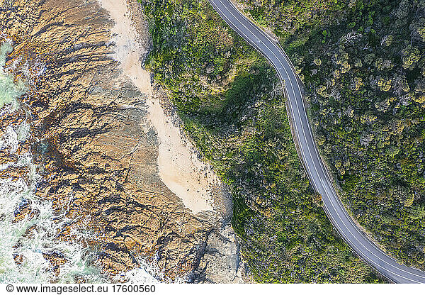 Australia  Victoria  Aerial view of rocky coastline and stretch of Great Ocean Road in summer