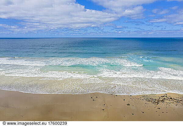 Australia  Victoria  Aerial view of sandy beach along Great Ocean Road in summer with clear line of horizon over sea in background