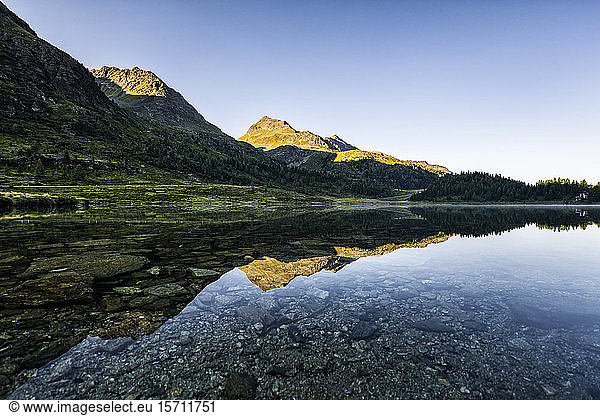 Austria  East Tyrol  Shiny lake reflecting mountains in Defereggen Valley