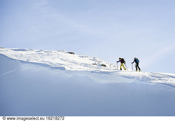 Austria  Men skiing on mountain at Alpbachtal
