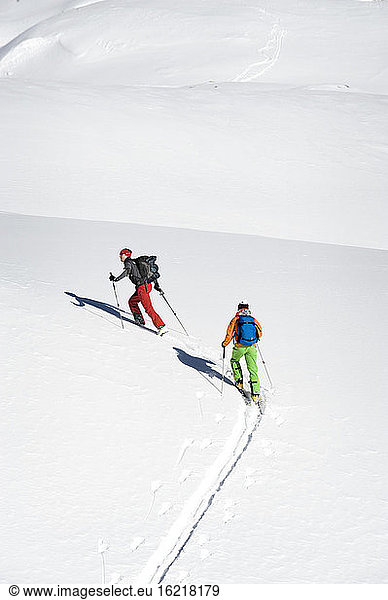 Austria  Men skiing on mountain at Salzburger Land