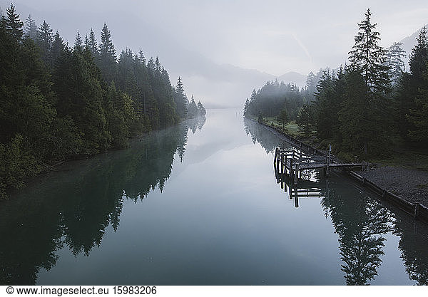 Austria  Plansee  Lake Plansee and wooden pier in fog at Austrian Alps