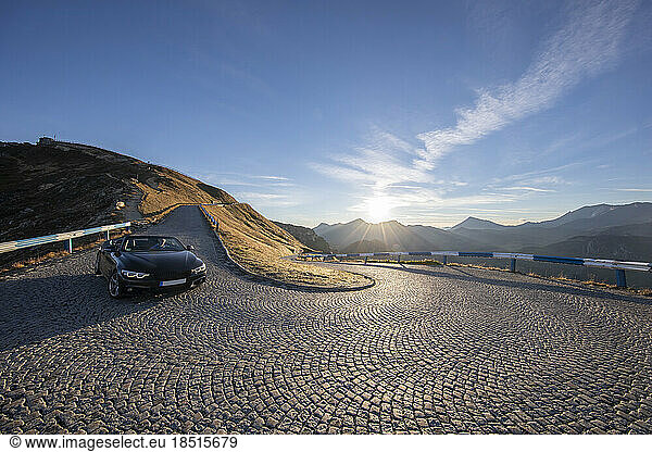 Austria  Salzburger Land  Car driving down Grossglockner Road at sunrise