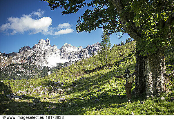 Austria  Salzburger Land  Male hiker looking at Bischofsmutze mountain visible in background