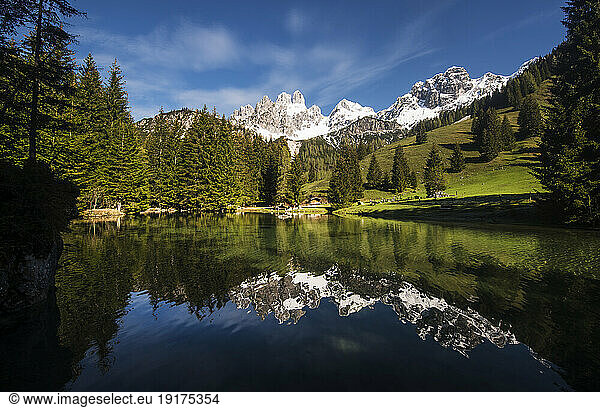 Austria  Salzburger Land  Scenic view of Grosse Bischofsmutze reflecting in Almsee lake