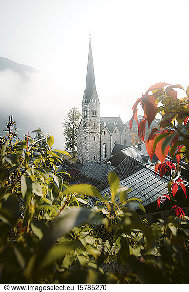 Austria  Salzkammergut region  Hallstatt church tower in fog at sunrise