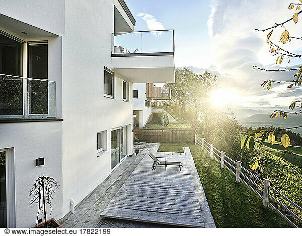 Austria  Tyrol  Exterior of modern hilltop house with sun setting in background