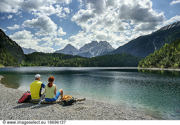 Austria  Tyrol  Hiking couple relaxing on shore of Blindsee