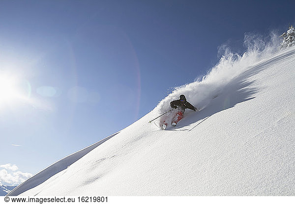 Austria  Tyrol  Mid adult man skiing in snow at Kitzbuehel