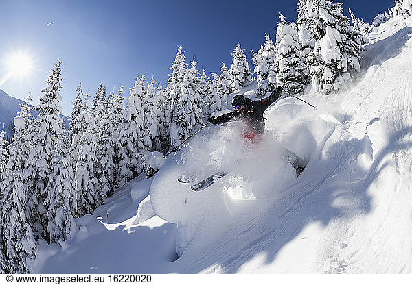 Austria  Tyrol  Mid adult man skiing in snow at Kitzbuehel