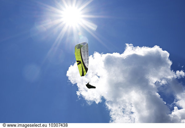 Austria  Tyrol  paraglider in front of a cloud seen from below