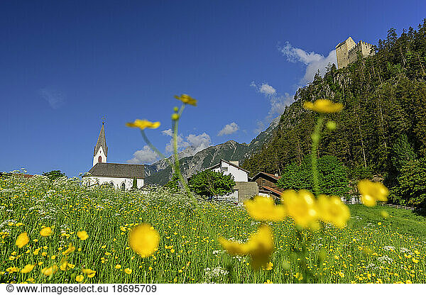 Austria  Tyrol  Summer meadow in front of village at foot of Kronburg castle