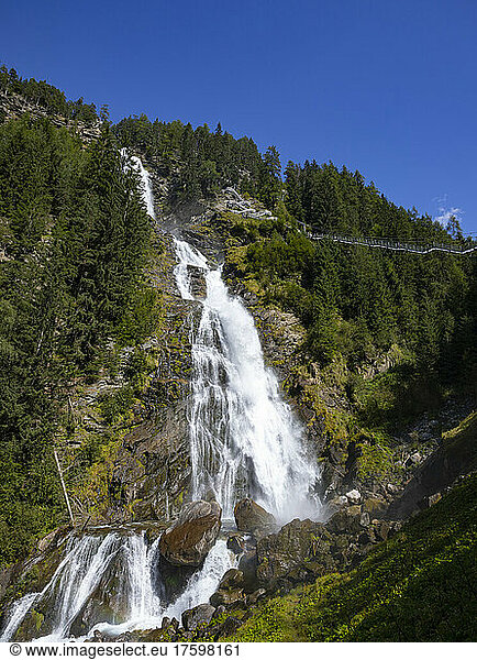 Austria  Tyrol  Umhausen  View of Stuiben Falls in summer with suspension bridge in background