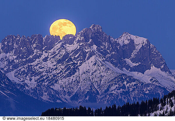 Austria  Tyrol  Yellow moon rising over Wiedersberger Horn at dusk