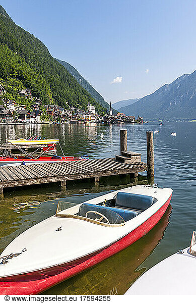 Austria  Upper Austria  Hallstatt  boat moored on shore of Lake Hallstatt with town in background