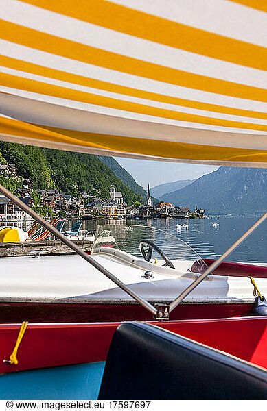 Austria  Upper Austria  Hallstatt  boats moored on shore of Lake Hallstatt with town in background