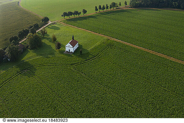 Austria  Upper Austria  Reichersberg  Drone view of Doblkapelle surrounded by green agricultural field