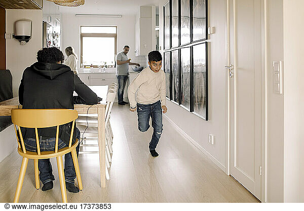 Autistic boy running in living room