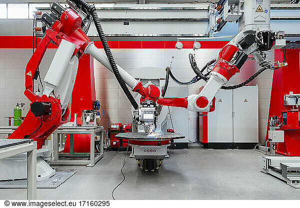 Automatisierte Industrieroboter schweißen Metall in einer Fabrik