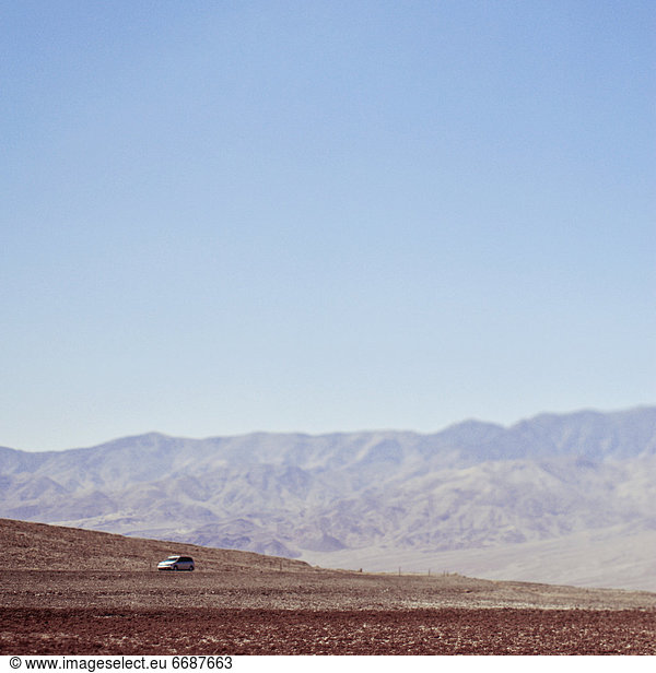 Automobile Driving Through Desert