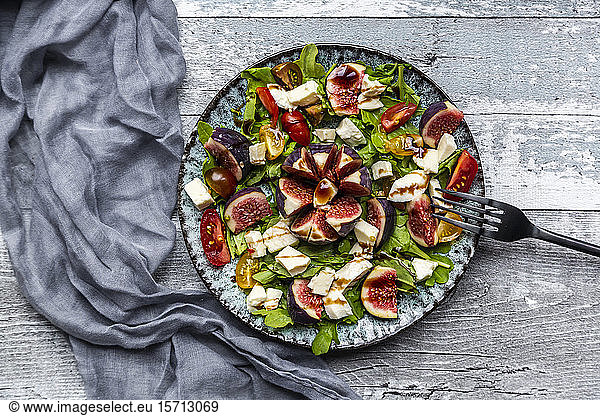 Autumnal salad with figs  arugula  mozzarella and tomatoes