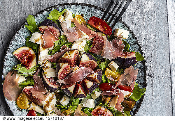 Autumnal salad with figs  arugula  mozzarella  tomatoes and parma ham
