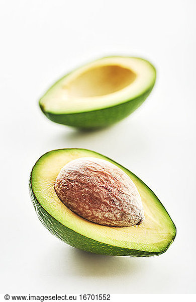 Avocado cut in half isolated on a white background