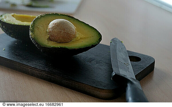 avocado cut on a cutting table. black background