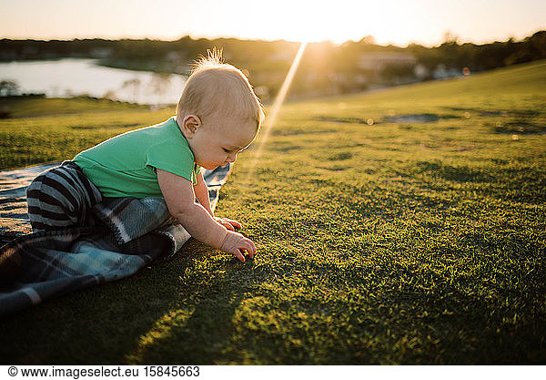Baby boy at the park during sunset.