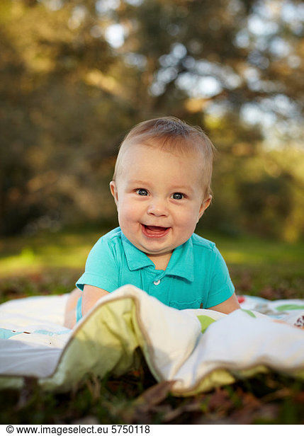 Baby boy on blanket in the park