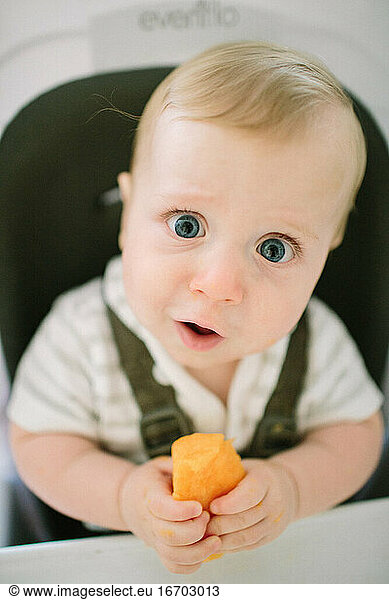 Baby making a funny expression as he tries a new food