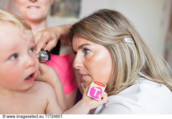 Baby (6-11 months) being examined by doctor