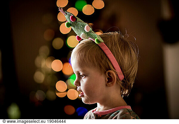 baby/toddler with christmas tree headband and christmas bokeh