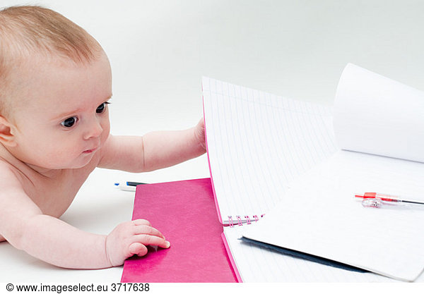 Baby with notebooks