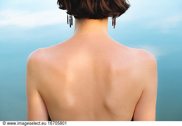 Back of a woman in ntural blue backdrop. Symmetry  natural beaut