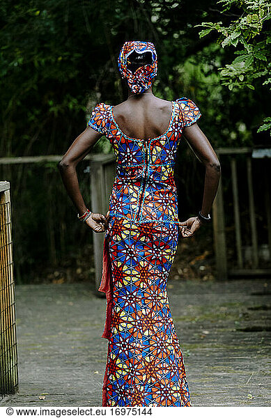 Back Portrait woman wearing african ankara dress by dock outdoor