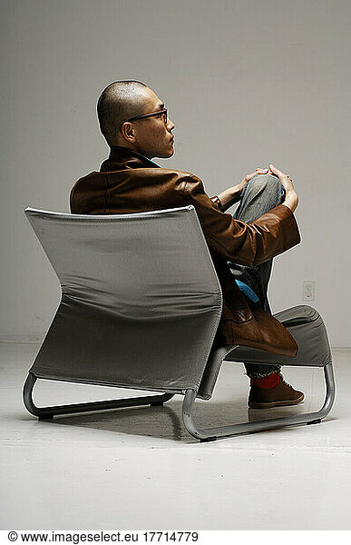Back View Of Man Sitting In Chair